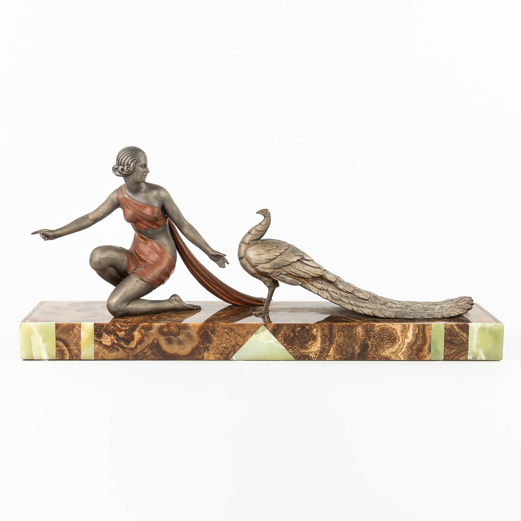 OUDINE (XIX-XX) 'Lady with Peacock' made of spelter, art deco period mounted on onyx. (H:35cm)