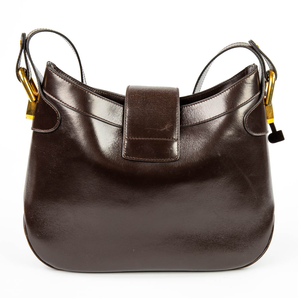 A purse made of brown leather and marked Delvaux. Mounted with gold-plated elements. (H:23cm)