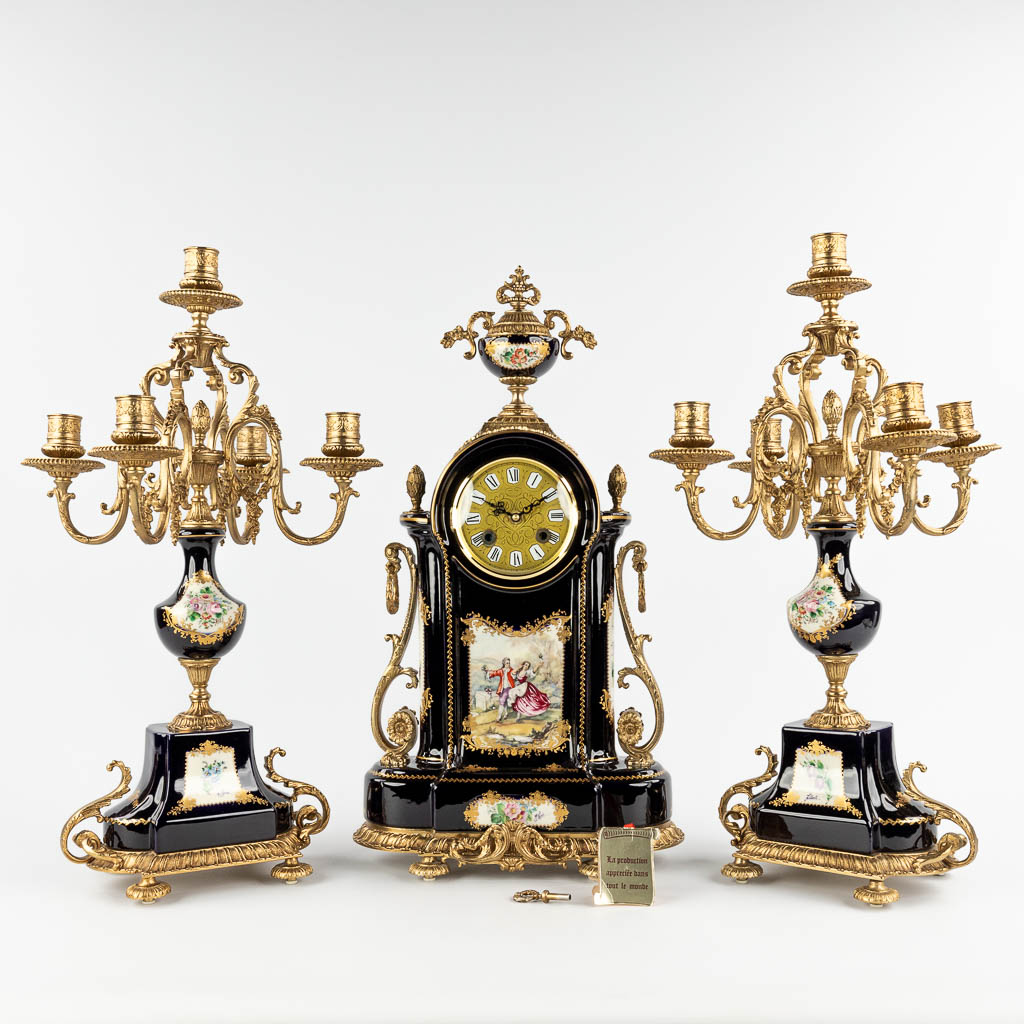 A three-piece mantle garniture clock with candelabra, porcelain mounted with bronze, marked A.C.F. decor de Sèvres (D:17 x W:32