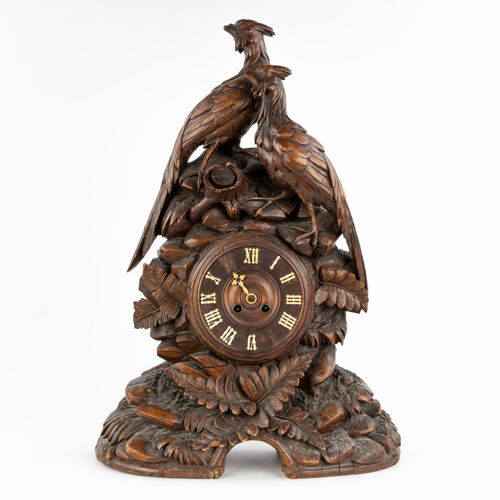 An antique 'Black Forest' mantle clock, decorated with sculptured wood pheasants. Circa 1900. (D:17 x W:44 x H:63 cm)