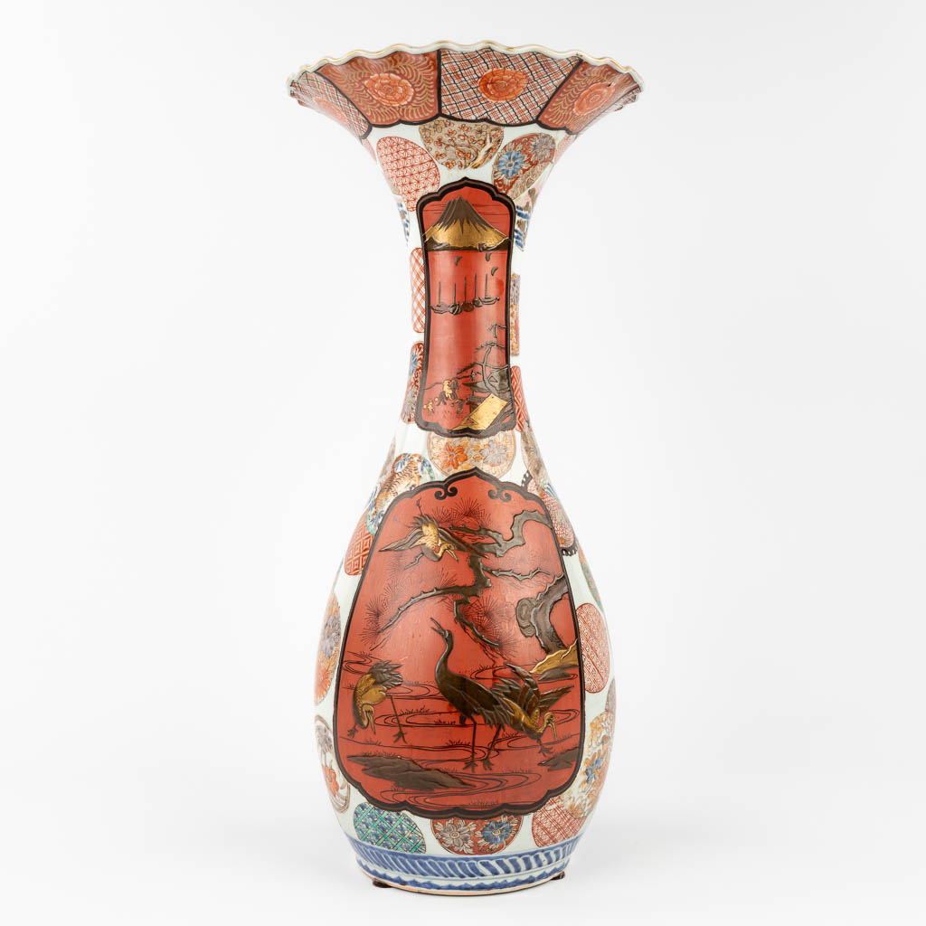 A Japanese Imari vase with a decor of cranes and landscapes. 19th/20th C.  (H:62 x D:28 cm)