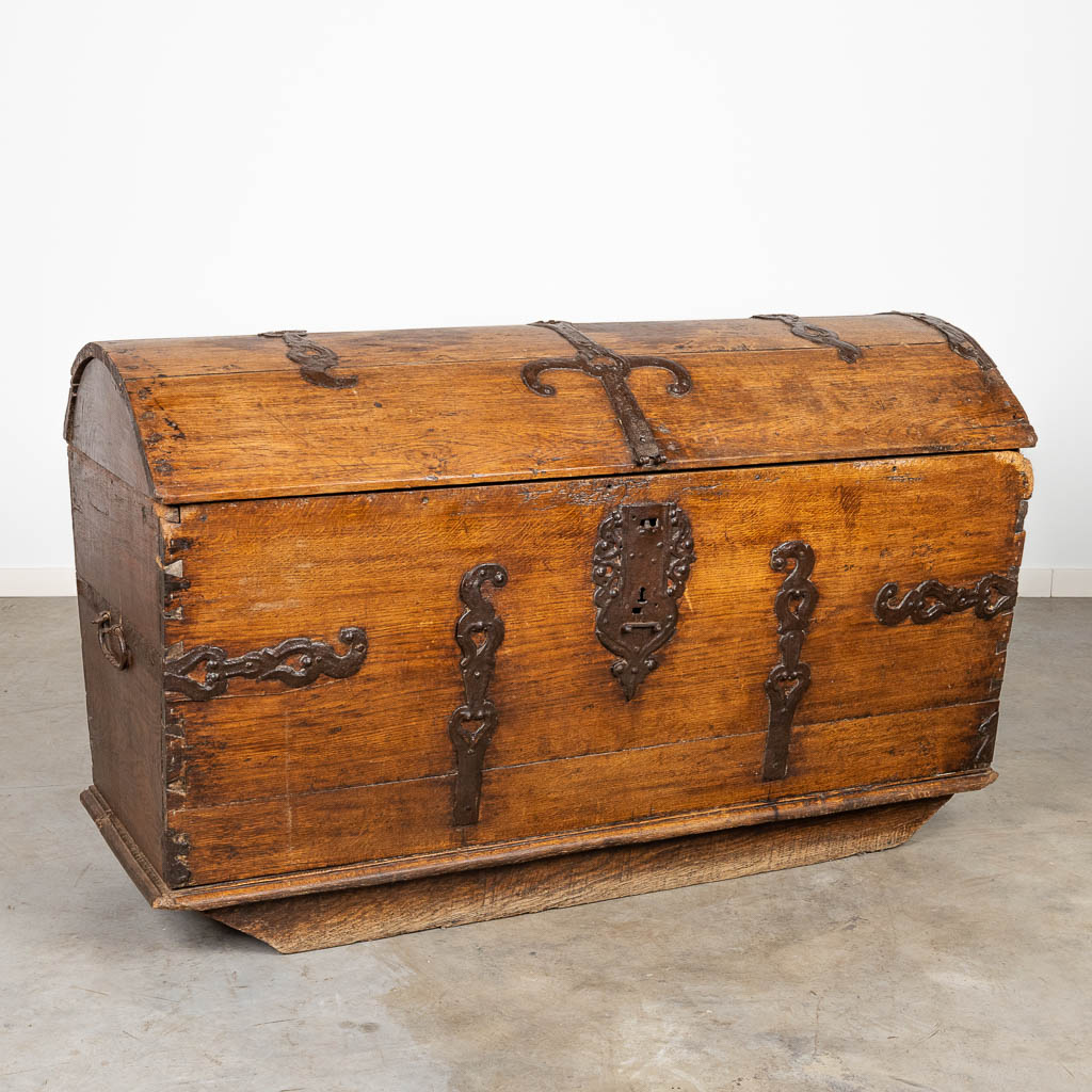 An antique chest, decorated with metal. 