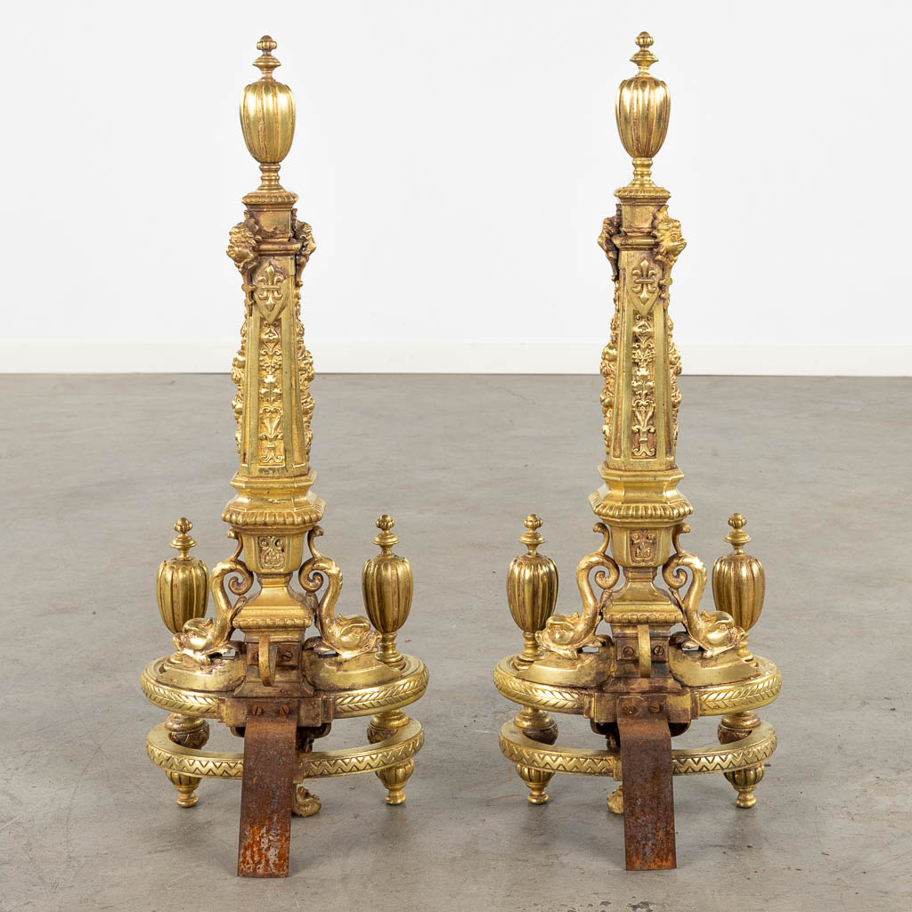 A pair of fireplace bucks, gilt bronze decorated with lion