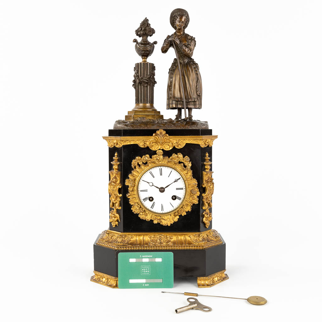 A black marble and bronze mantle clock 