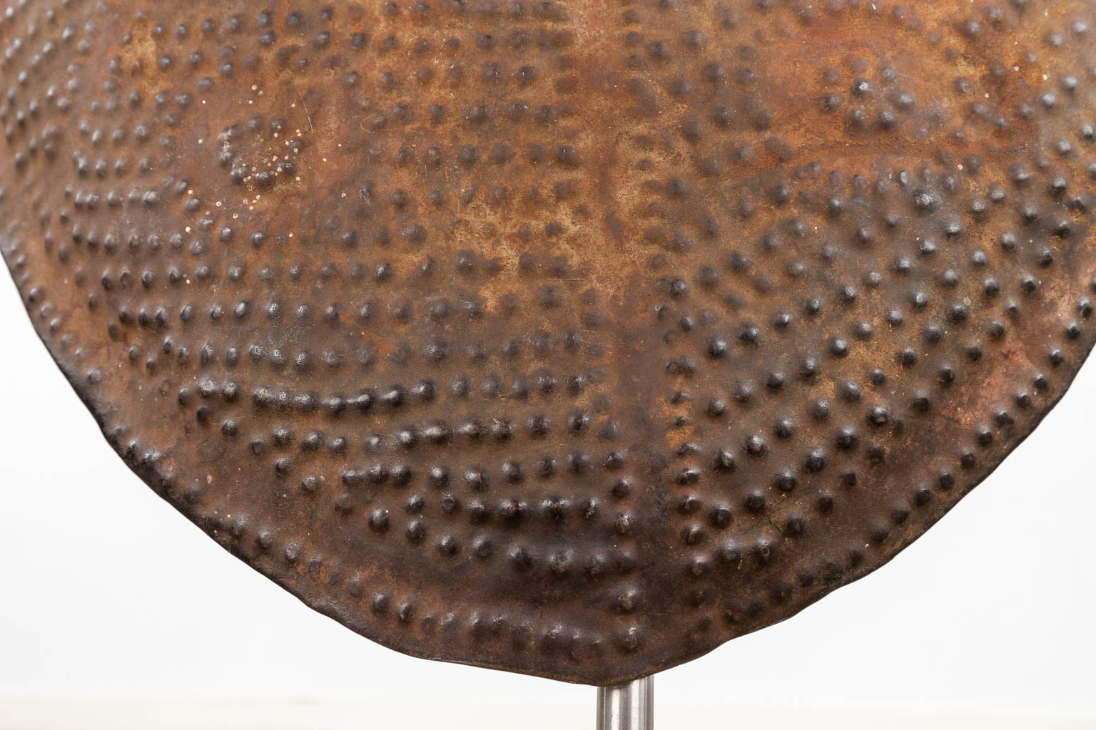 A decorative African shield, mounted on a stand. (W:60 x H:85 cm)