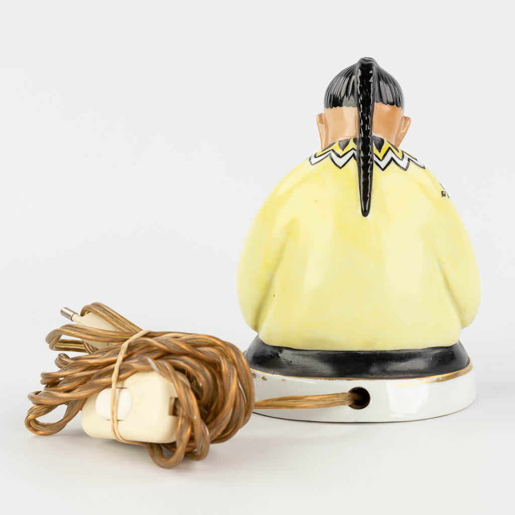 An insence burner in the shape of a Chinese figurine, interior with a lamp. Circa 1920. (L: 9 x W: 12 x H: 16 cm)