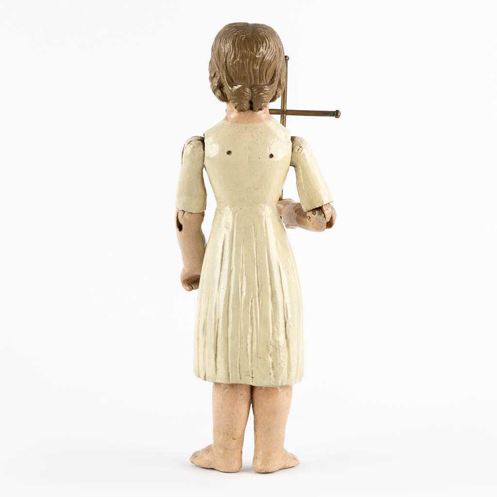An antique patinated and wood-sculptured doll. 19th C. (L:11,5 x W:17 x H:45 cm)