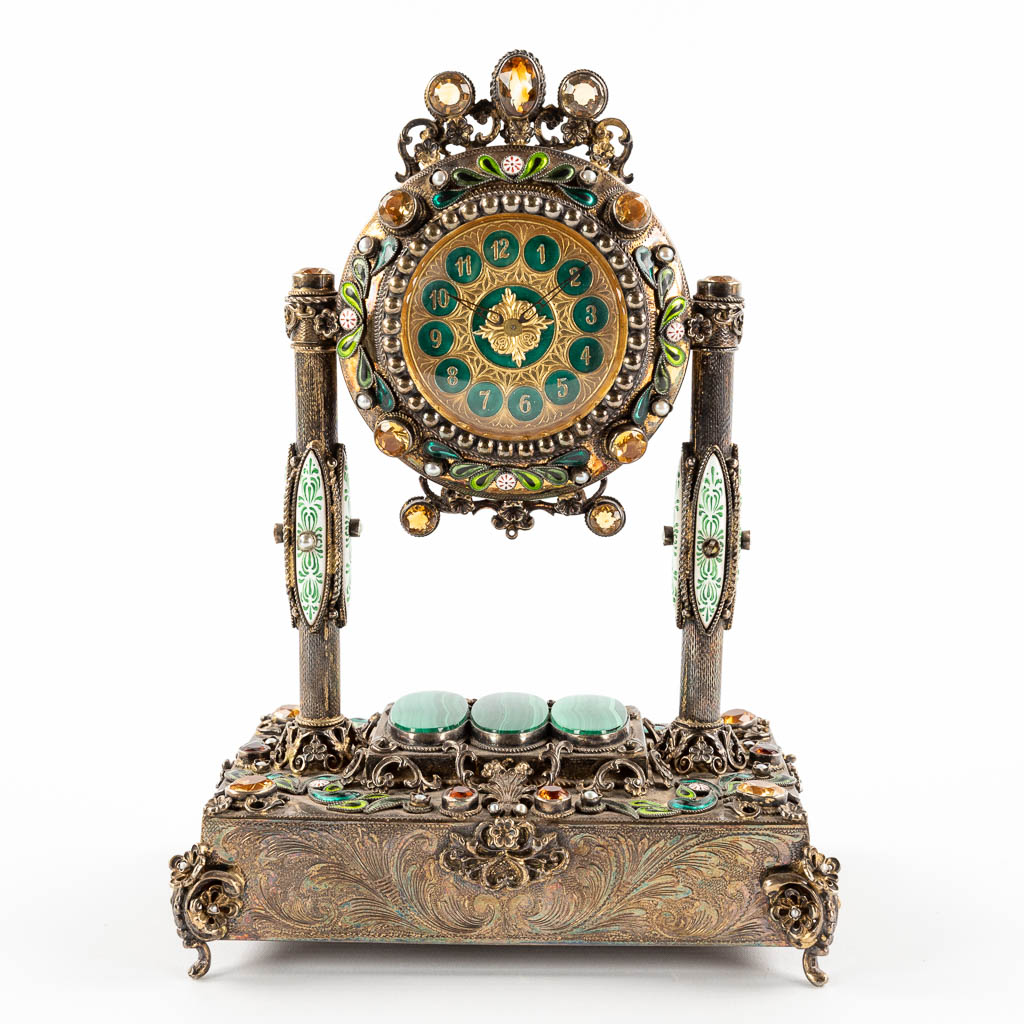 A mantle clock with music box, silver-plated metal and semi-precious stones. Vienna, 20th C. (D:11 x W:16 x H:25 cm)