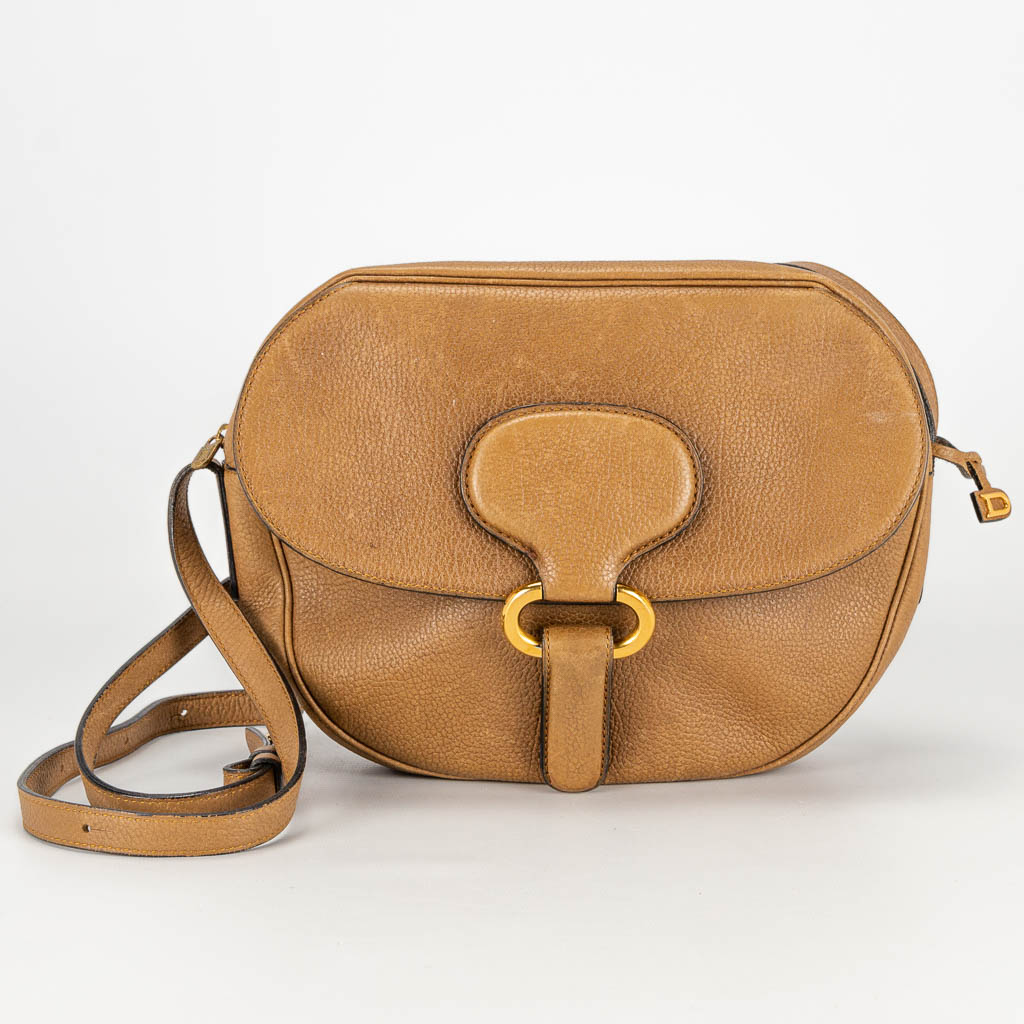 A purse made of brown leather and marked Delvaux