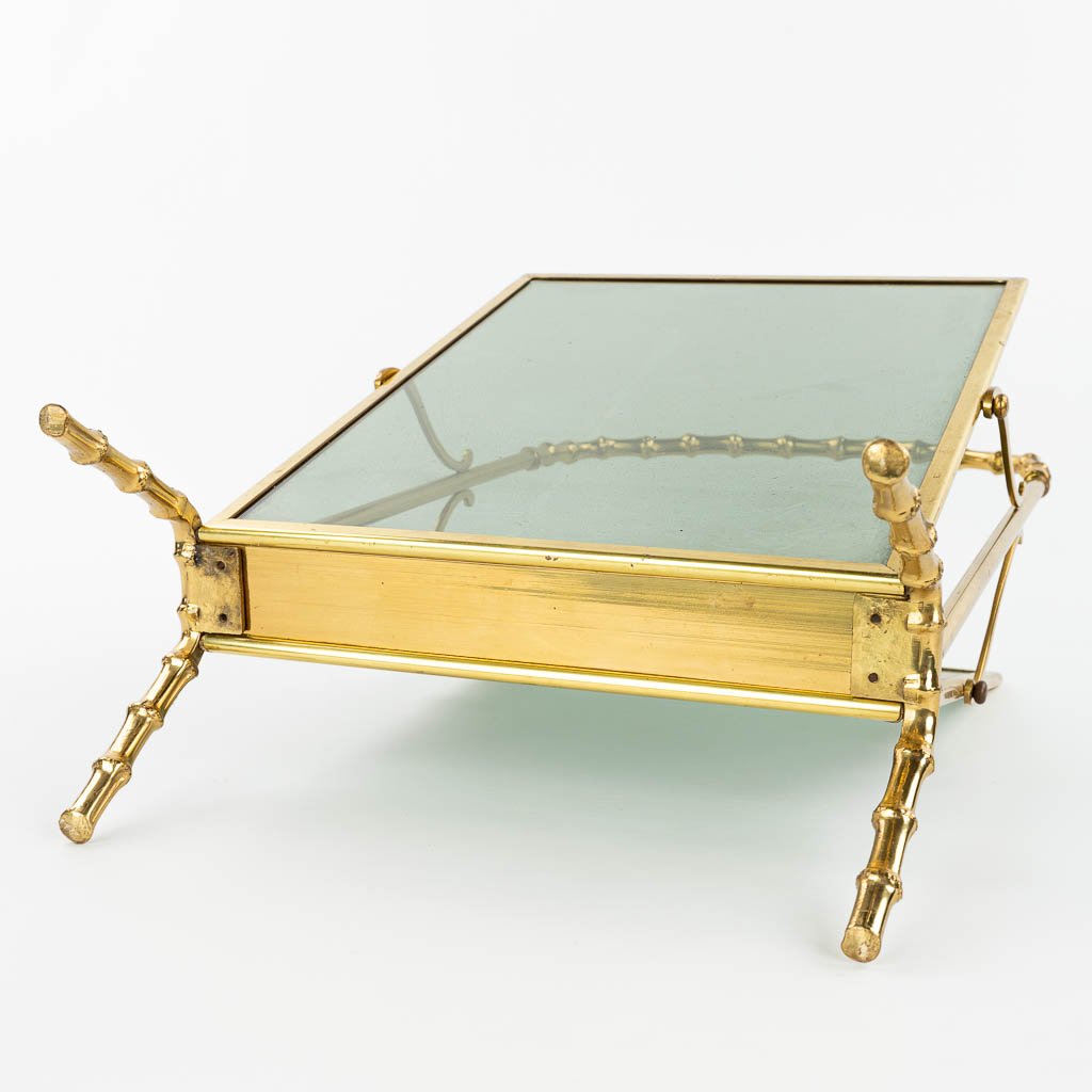 A faux bamboo newspaper holder, brass and glass, in the style of Jacques Adnet. (H:57cm)