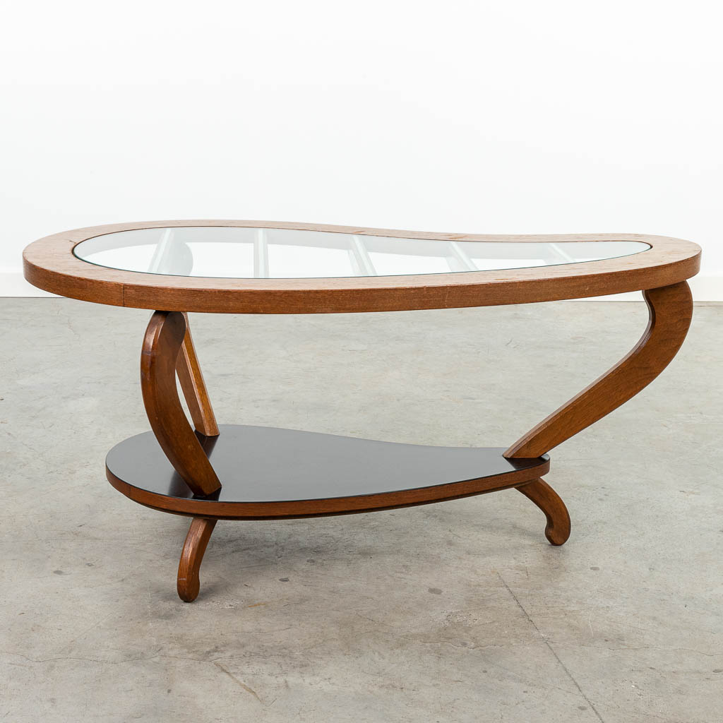 A mid-century coffee table made of wood and glass. 