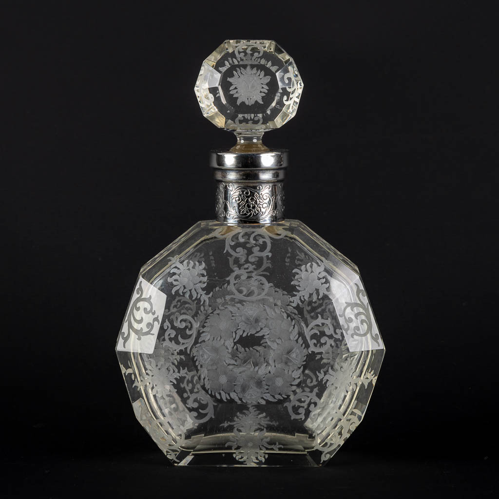 Een parfumfles, geëtst en gemonteerd met zilver. Glas, 19de eeuw. (L:8 x W:17 x H:26,5 cm)