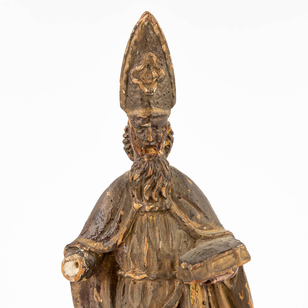 An antique wood sculptured figurine of Saint Augustine, 17th/18th C. (D:6 x W:7 x H:27 cm)