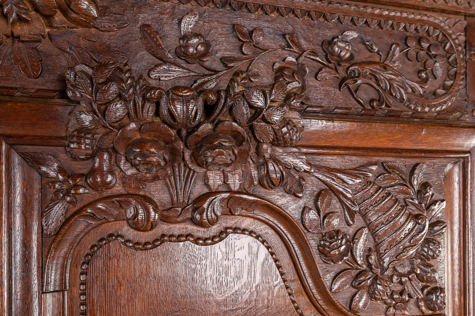 A richly sculptured and antique Normandy high cabinet, Armoire. France, 18th C.