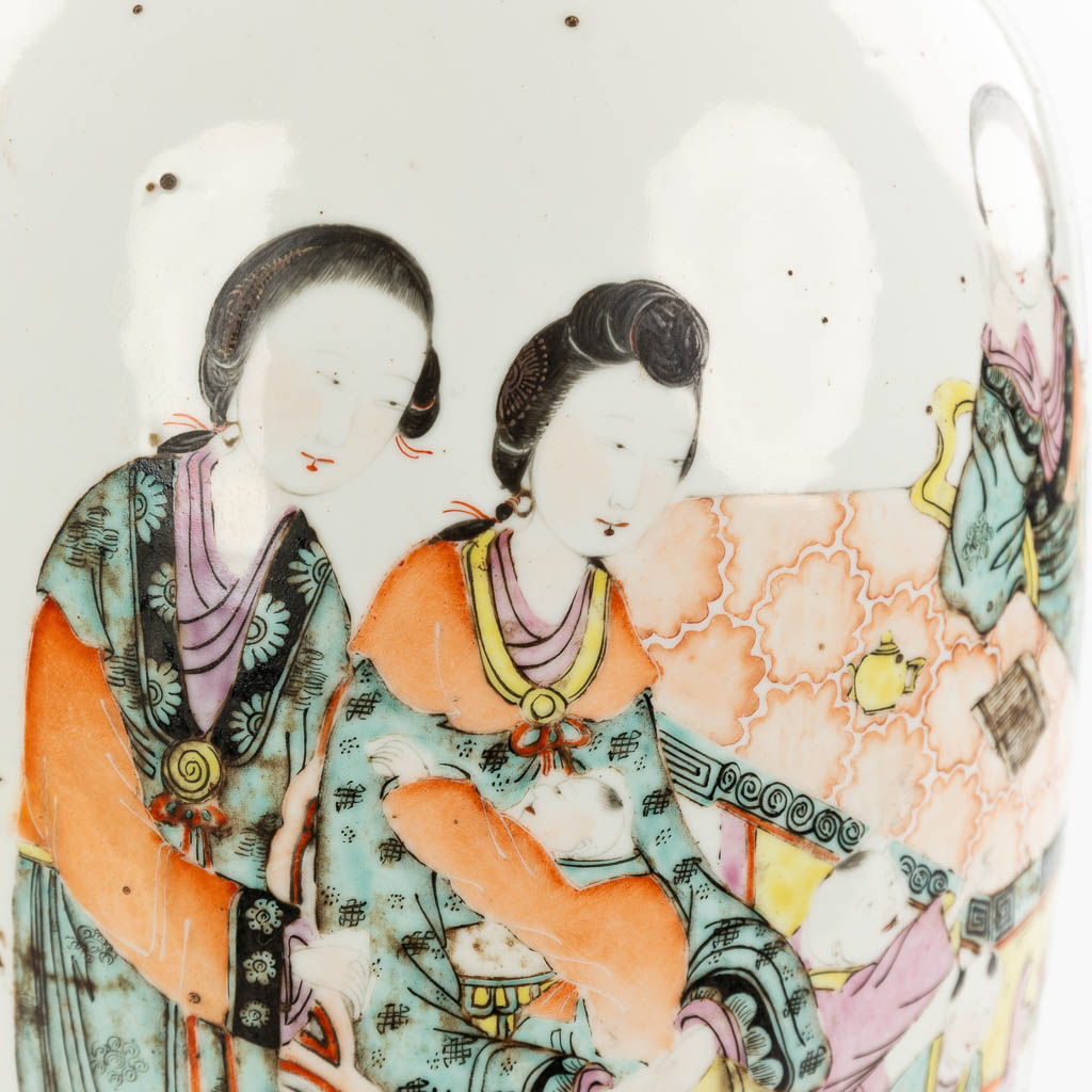 A Chinese vase made of porcelain and decorated with ladies and children in the garden. (H:58cm)