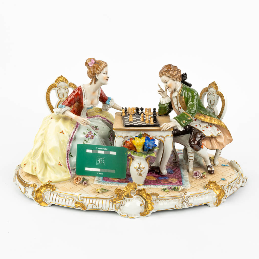 A large porcelain group of a chess-playing couple marked O. Enders and Volkstedt-Rudolstadt. (H:23cm)