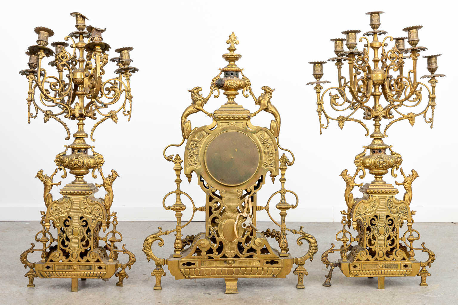 A three-piece mantle clock made of a bronze clock with candelabra. (H:70cm)