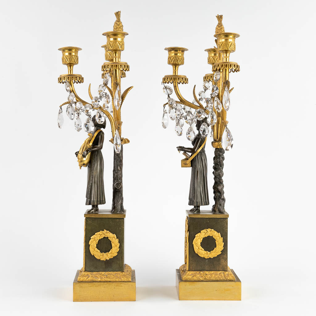 A pair of candelabra, gilt and patinated bronze, Empire, 19th C. (D:15 x W:24 x H:53 cm)
