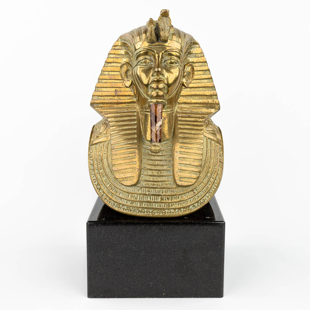  A death mask of Tutankhamun, made of polished bronze (L:18 x W:24 x H:32 cm)