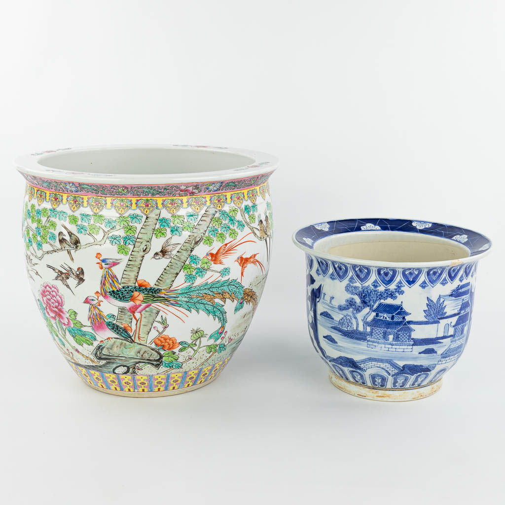 A set of 2 Chinese cache-pots made of porcelain of which 1 has a blue-white decor and the other a decor of peacocks. (H:35cm)
