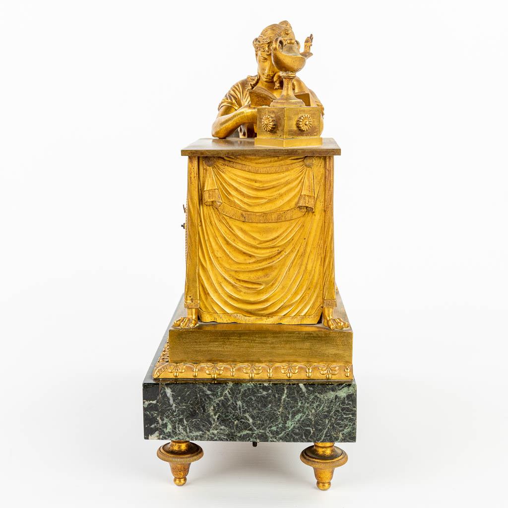 A table clock made of gilt bronze 'La Liseuze' after a model by Jean-André REICHE (1752-1817), Empire Period. (H:33cm