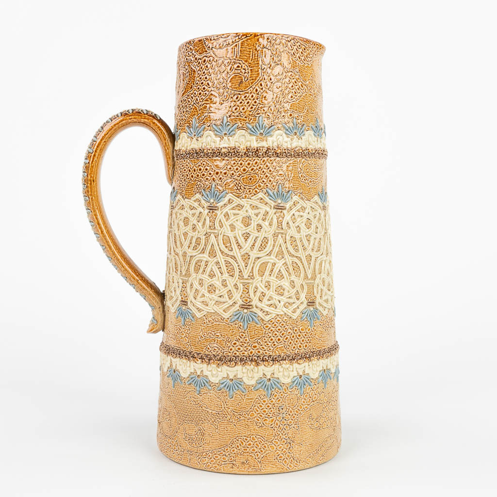A pitcher made of stoneware and marked Doulton Lambeth Slaters, Royal Doulton. (H:23cm)
