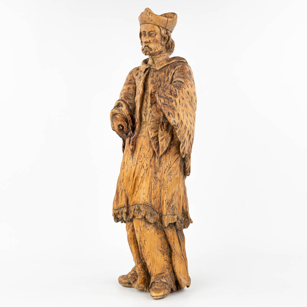 An antique wood sculptured statue of a holy figurine, made in Eastern Europe. (H:66cm)