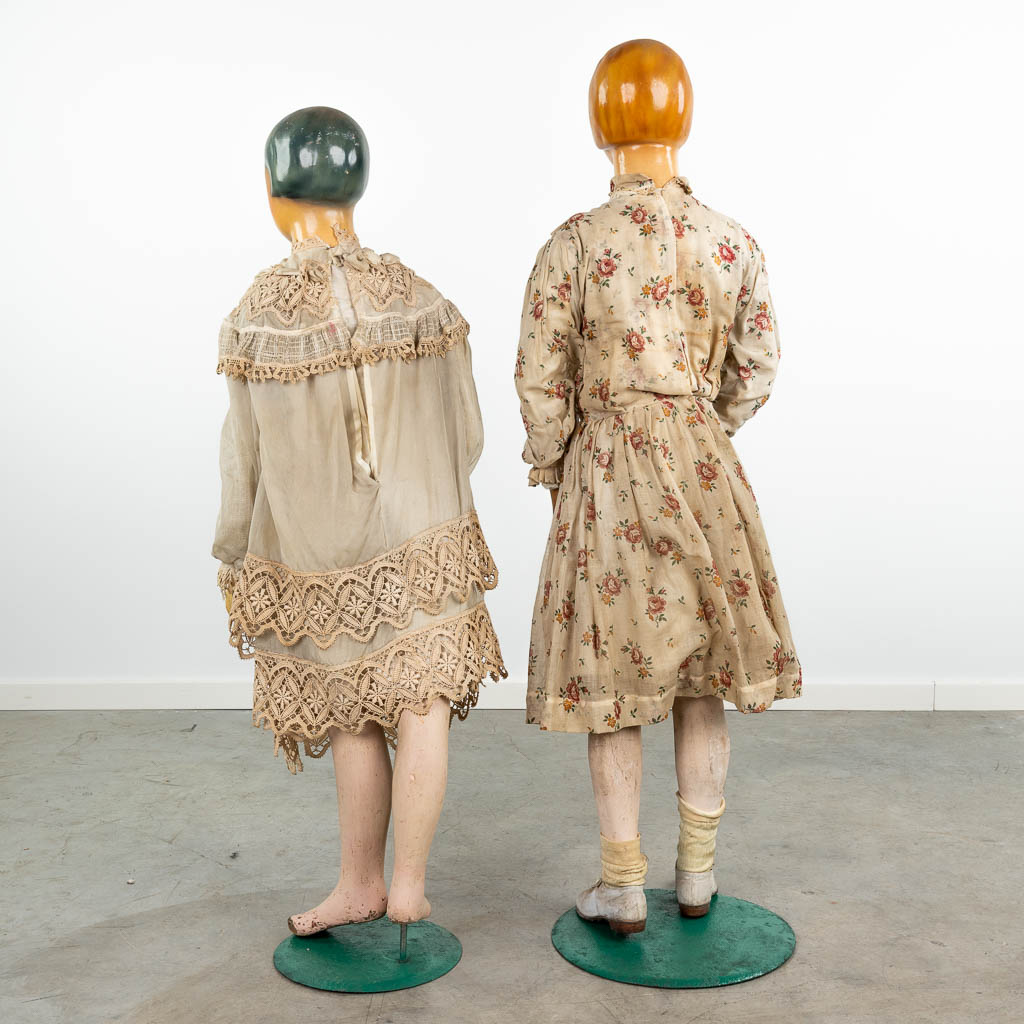 A pair of exceptional fitting dolls, with original clothing. (H:141cm)