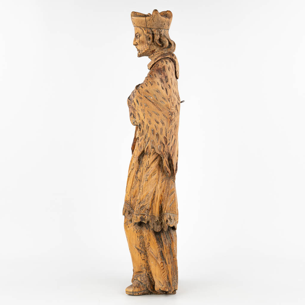An antique wood sculptured statue of a holy figurine, made in Eastern Europe. (H:66cm)