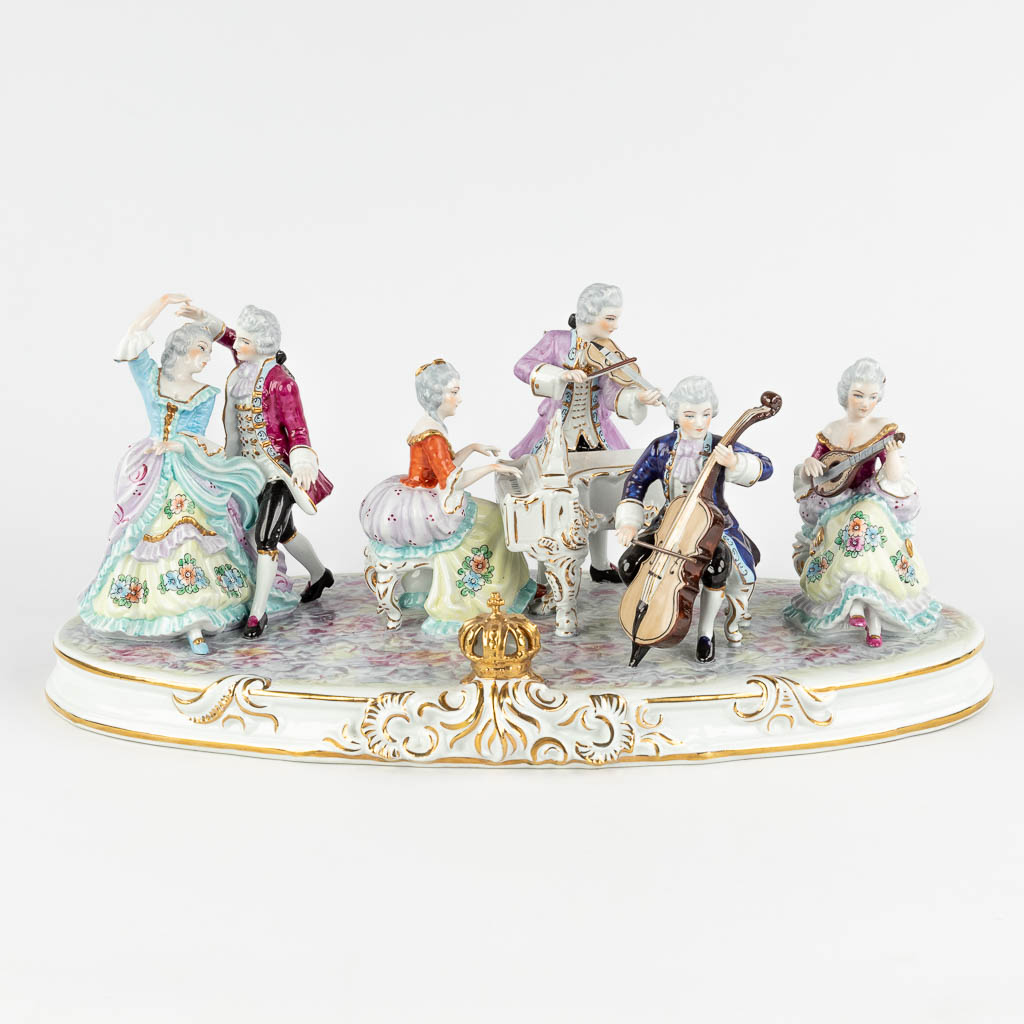 A large group 'Music and Dancers', polychrome Saxony porcelain, 20th C. (D:22 x W:47 x H:20 cm)