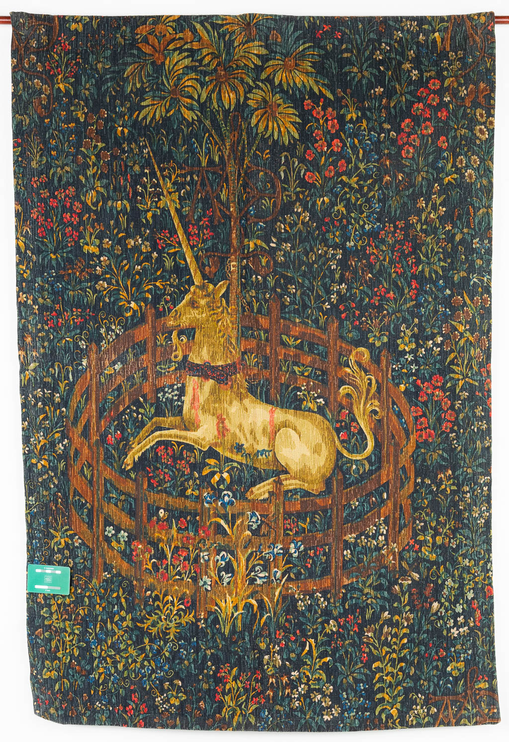 A tapestry with a printed image of a unicorn in a flower field. (H:136cm)