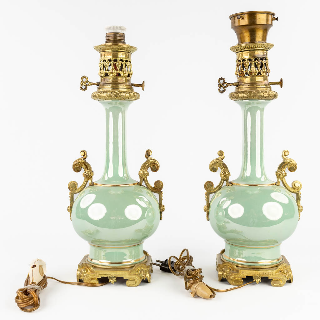 A pair of oil lamps, earthenware with a luster glaze and mounted with bronze. 20th C. (D:16 x W:17 x H:46 cm)