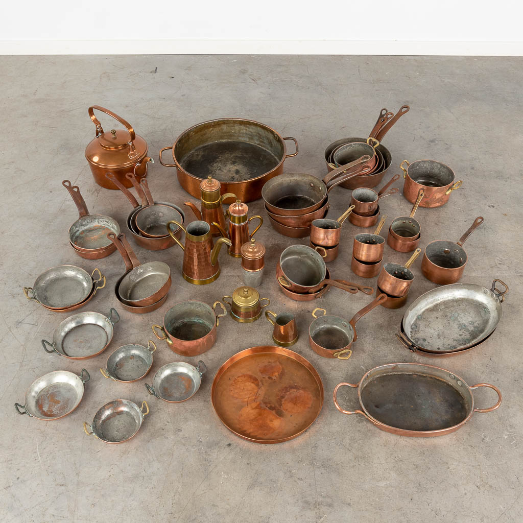 A large collection of copper pots and pans. Approximately 40 pieces. (D:41 x W:49 x H:11 cm)