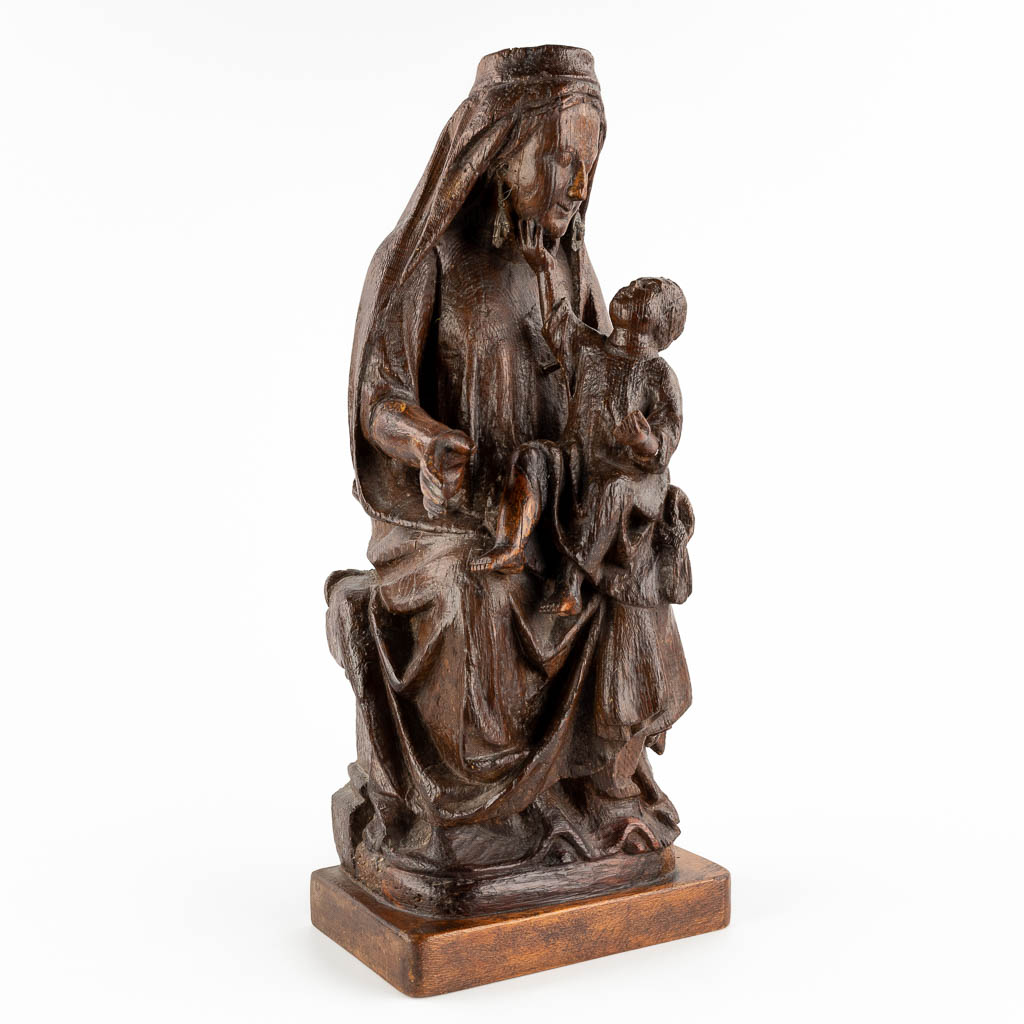 An antique wood sculpture of a mother with child, oak, 17th C. (D:17 x W:23 x H:55 cm)