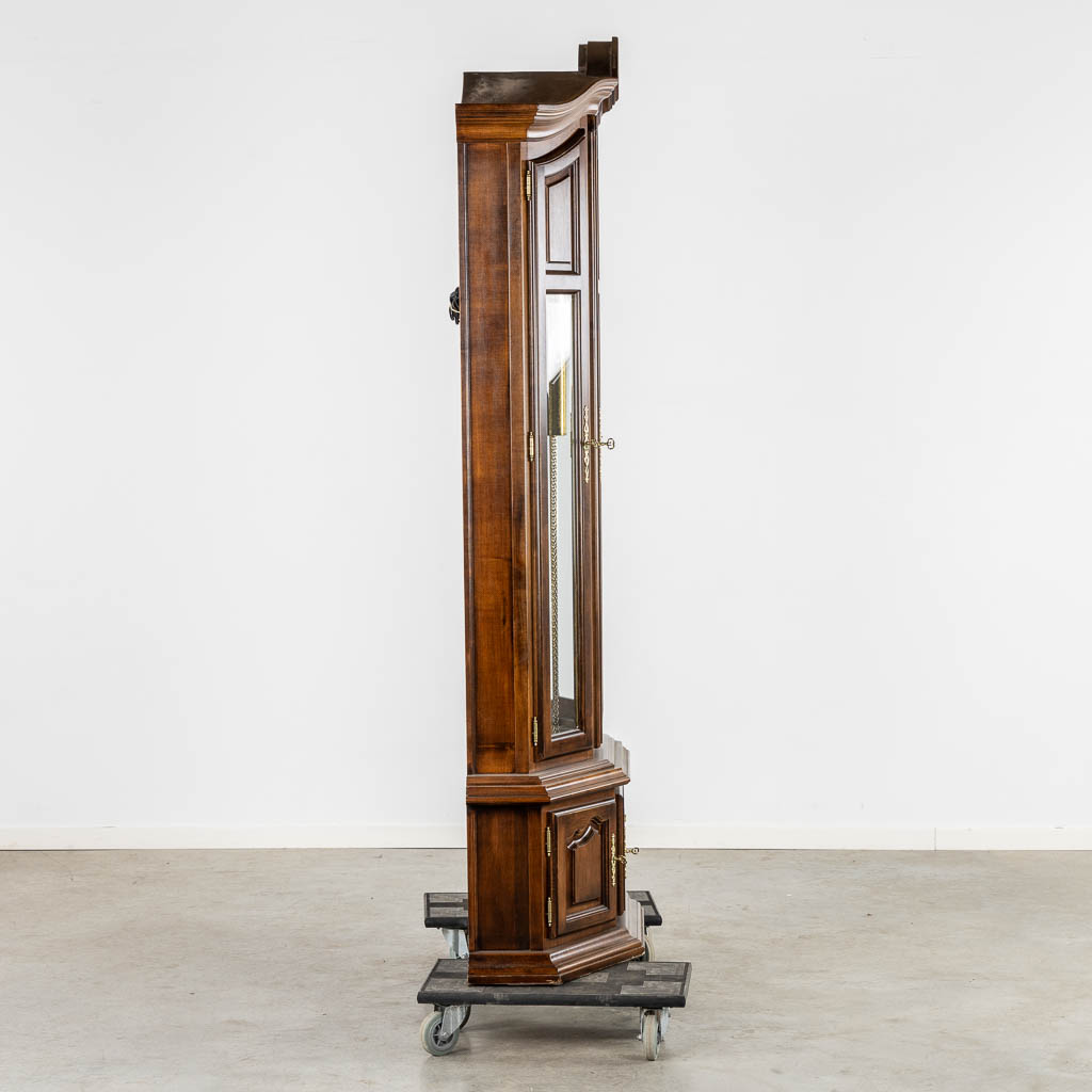 A decorative standing clock, with decorated weights. (L:40 x W:106 x H:214 cm)