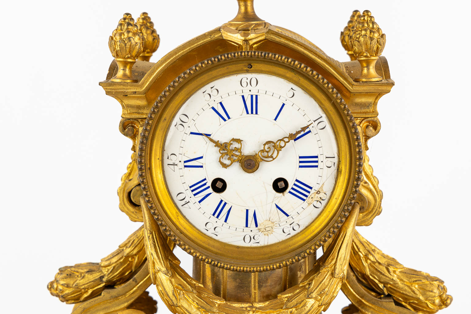 A three-piece mantle garniture clock and candelabra, gilt bronze. 19th C. (L:20 x W:32 x H:43 cm)