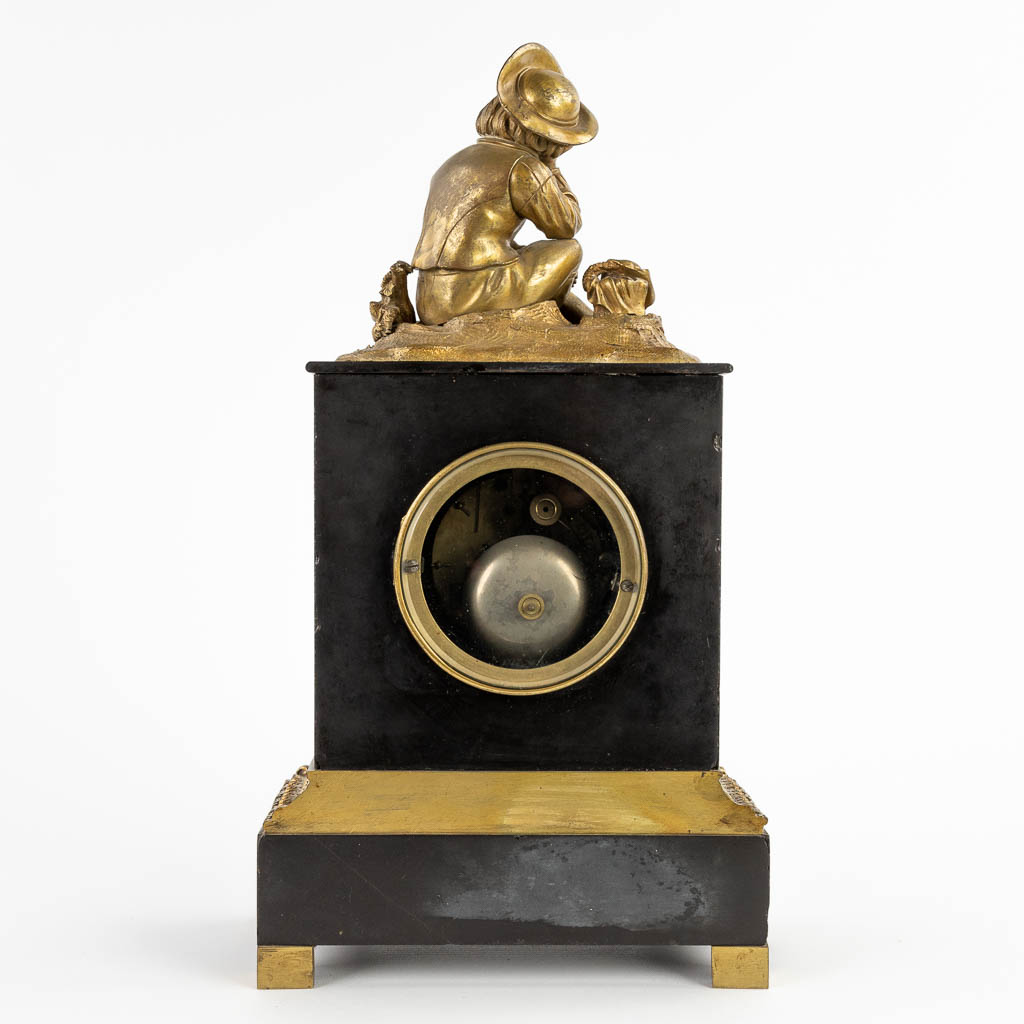 A mantle clock, black marble with a bronze figurine. 19th C. (D:12 x W:22 x H:41 cm)