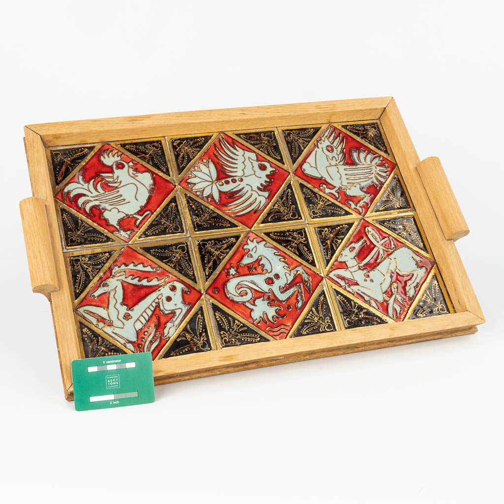 A serving tray made of ceramic tiles with animal figurines and made by Perignem during the 1950s. 