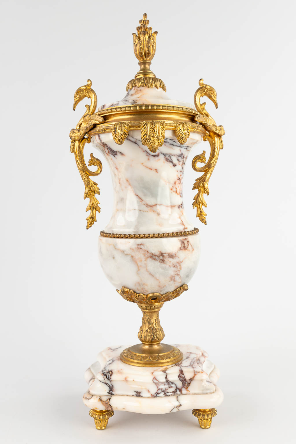 A three-piece mantle garniture portico clock and cassolettes, bronze mounted marble. 19th C. (D:19 x W:38 x H:51 cm)