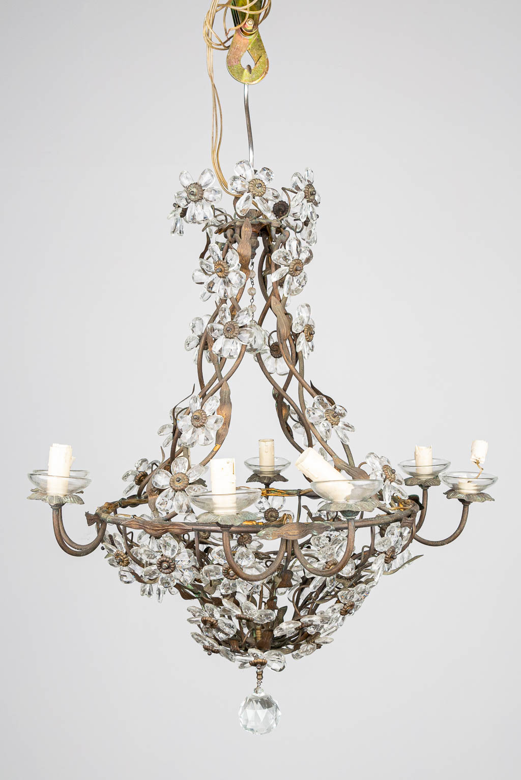 A large chandelier made of metal with glass flowers. 