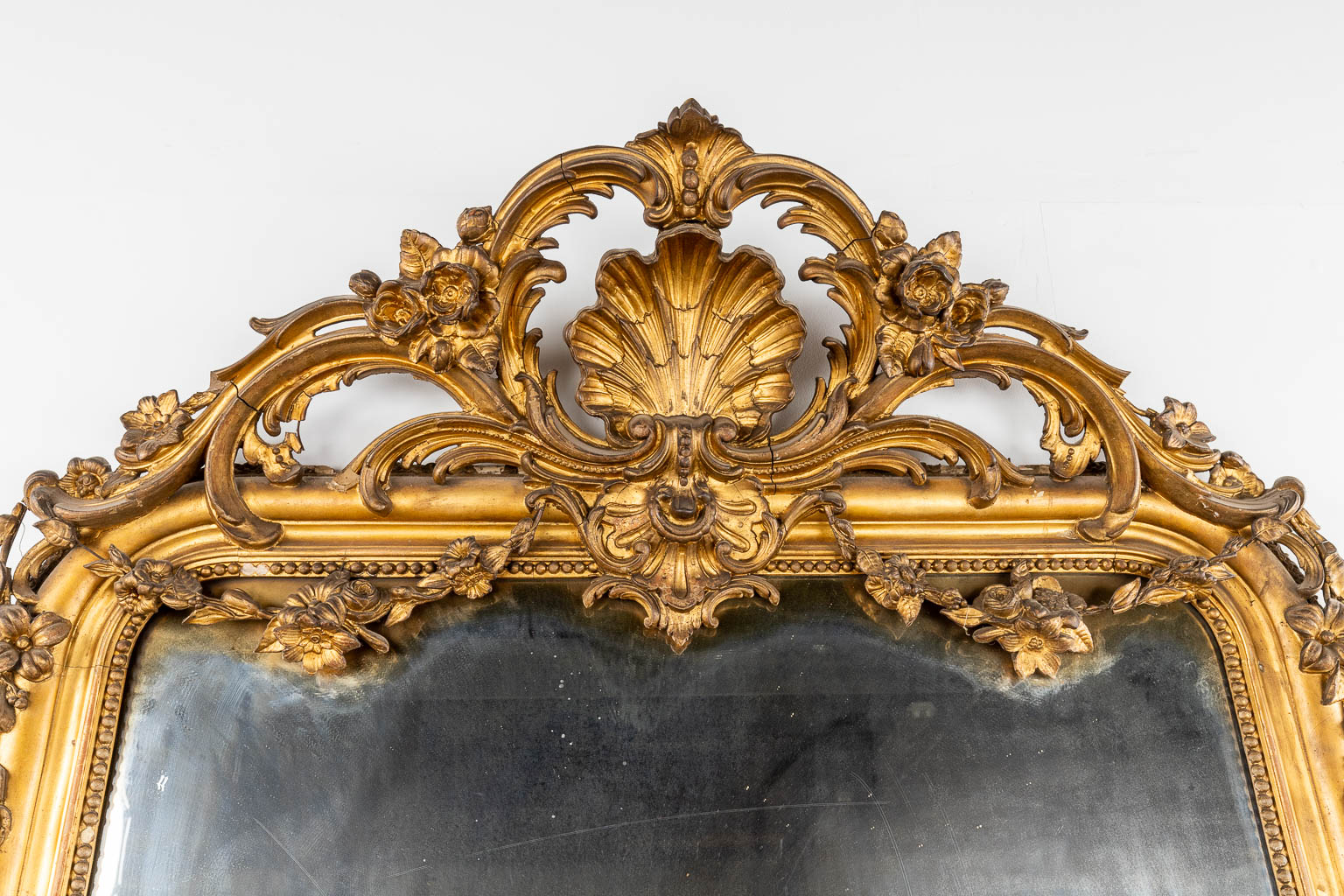 A large and antique mirror, gilt stucco in Louis XV style. 19th C. (W:130 x H:238 cm)