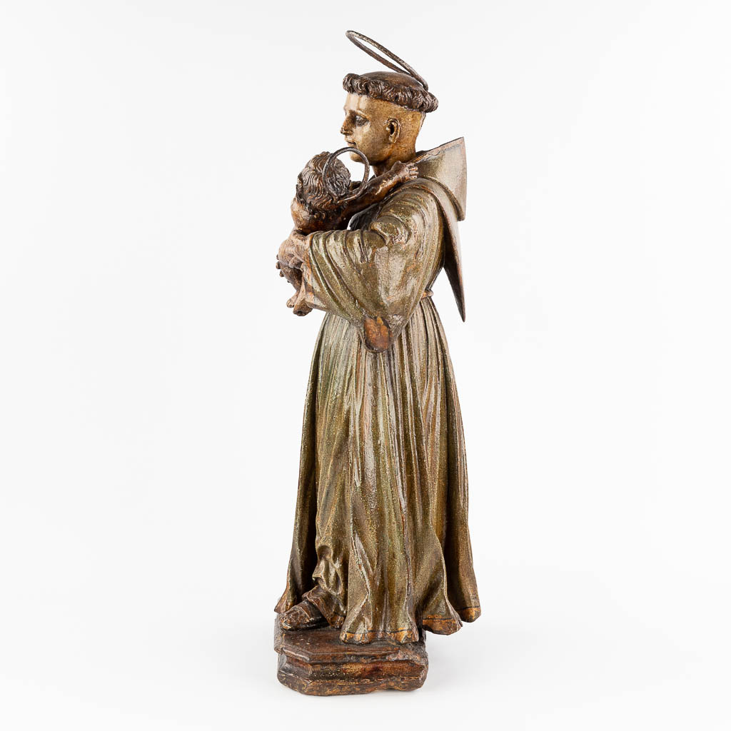 An antique wood-sculptured and polychrome figurine of Saint Anthony with a child. 18th century. (W: 28 x H: 74 cm)