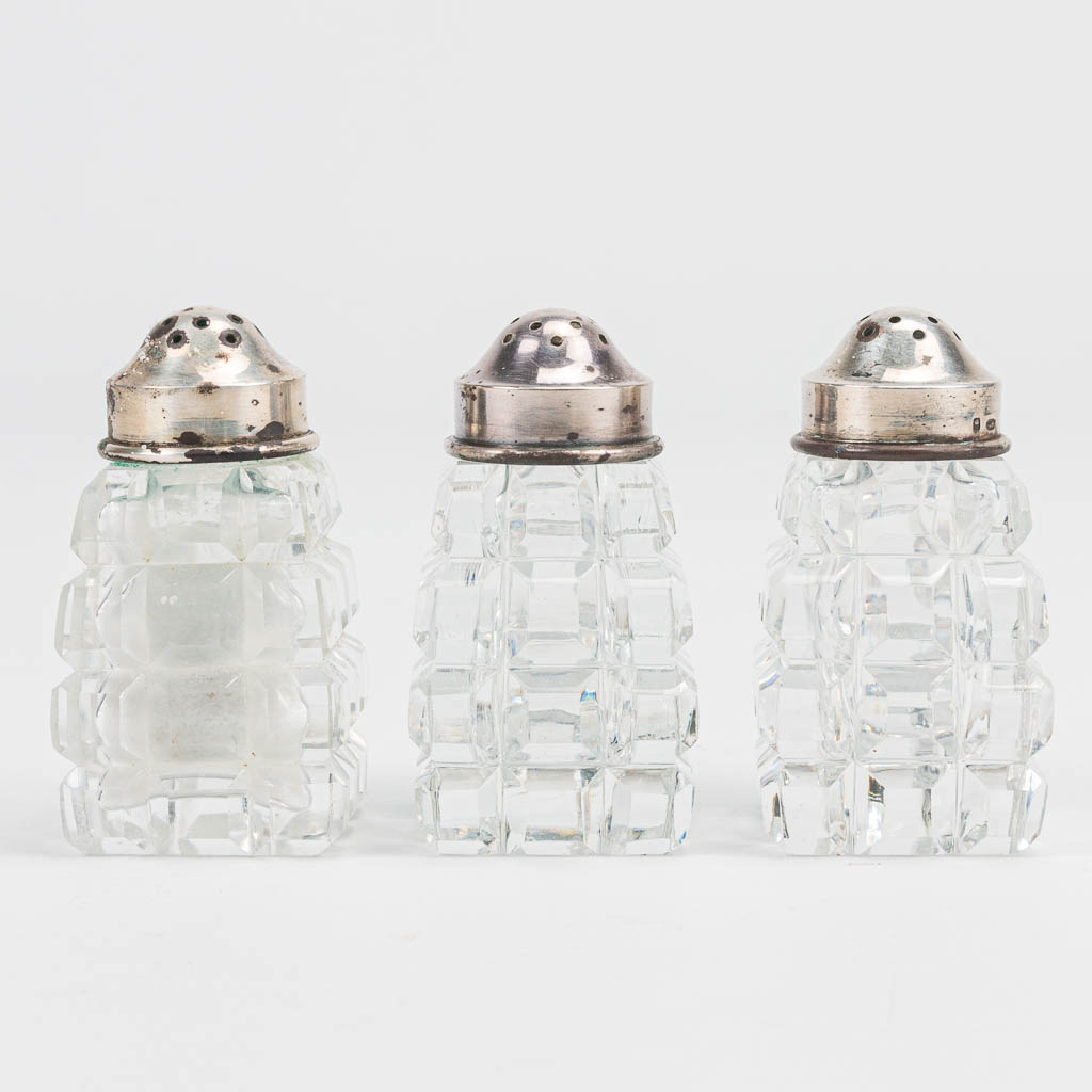 A set of 3 pepper and salt jars made of crystal with silver cap, marked Wolfers A835.