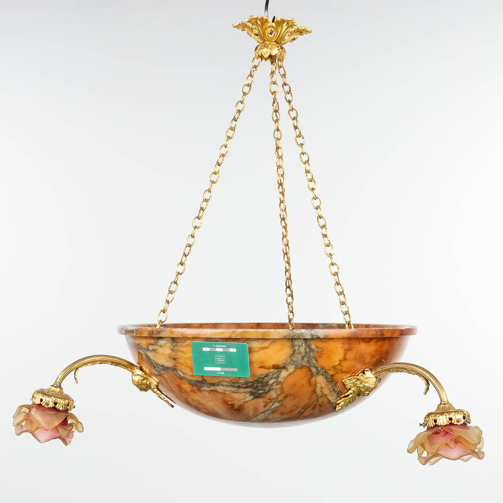 A chandelier made of a large alabaster bowl, mounted with bronze and glass roses. 