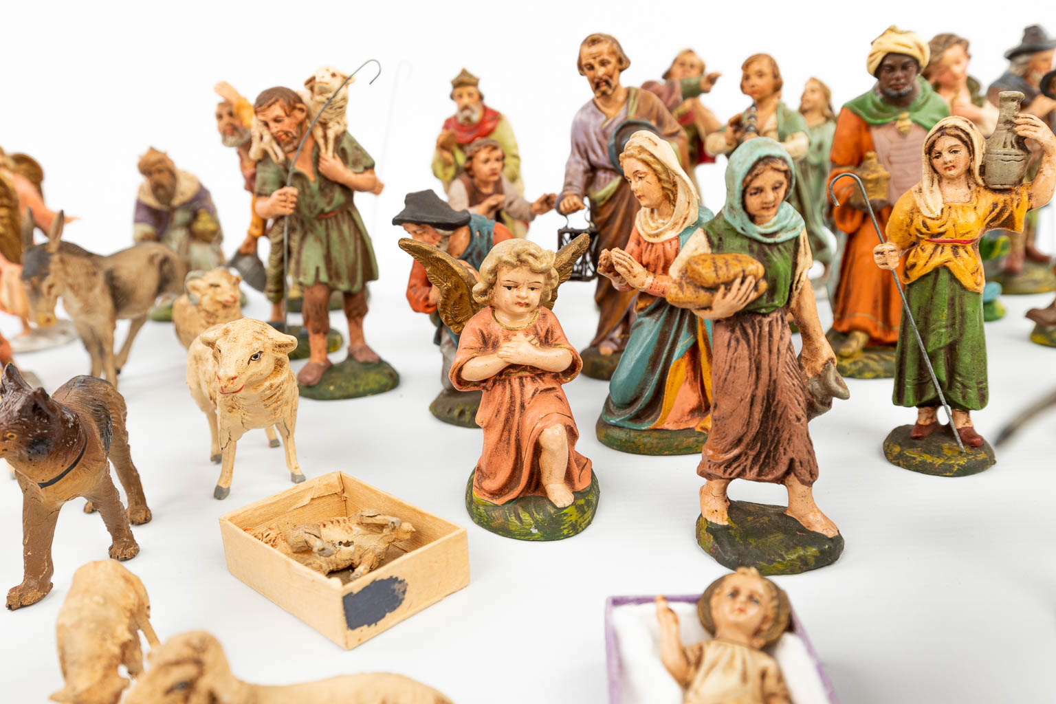A large and extended Nativity scene with figurines and animals made of papier maché. 