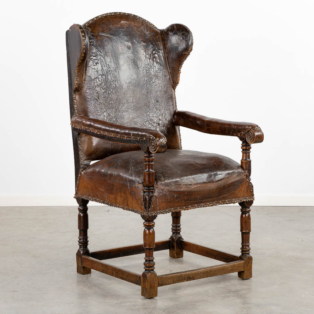 An antique Throne chair, leather on wood, great patina. 18th C. (L:76 x W:67 x H:125 cm)