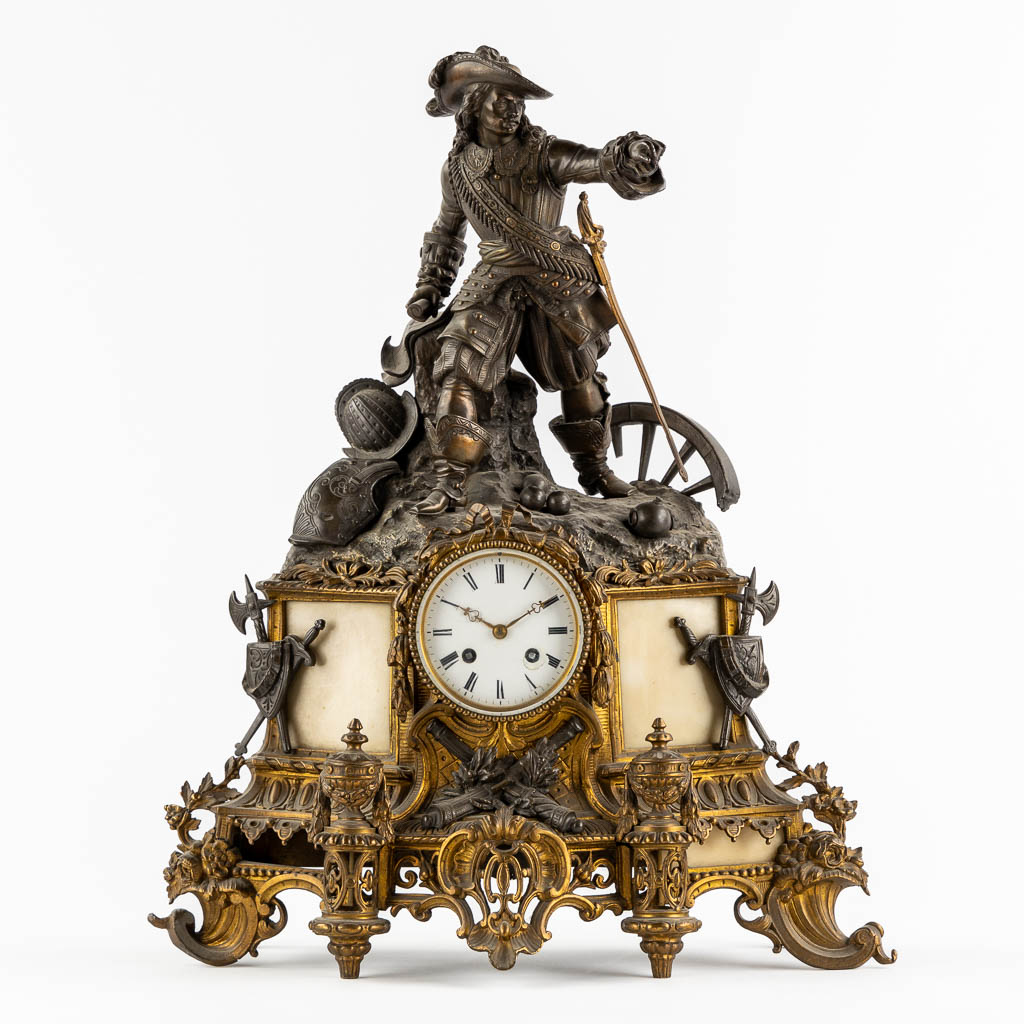 Lot 032 A mantle clock with a musketeer, patinated and gilt bronze on Carrara marble. 19th C. (L:17 x W:45 x H:55 cm)