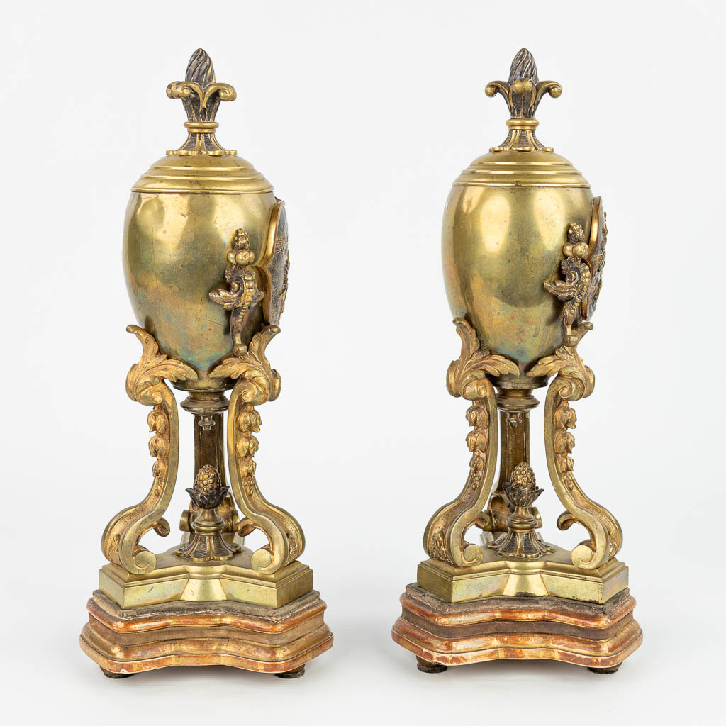 A pair of bronze cassolettes with images of knights in battle signed William McLaren. (H:36cm)