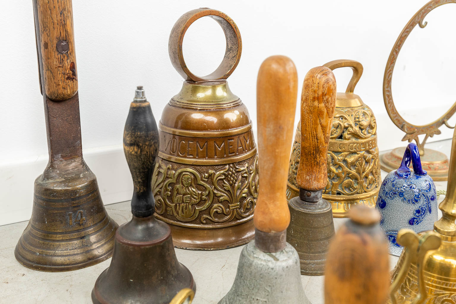 A large collection of table bells made of bronze and metal. 