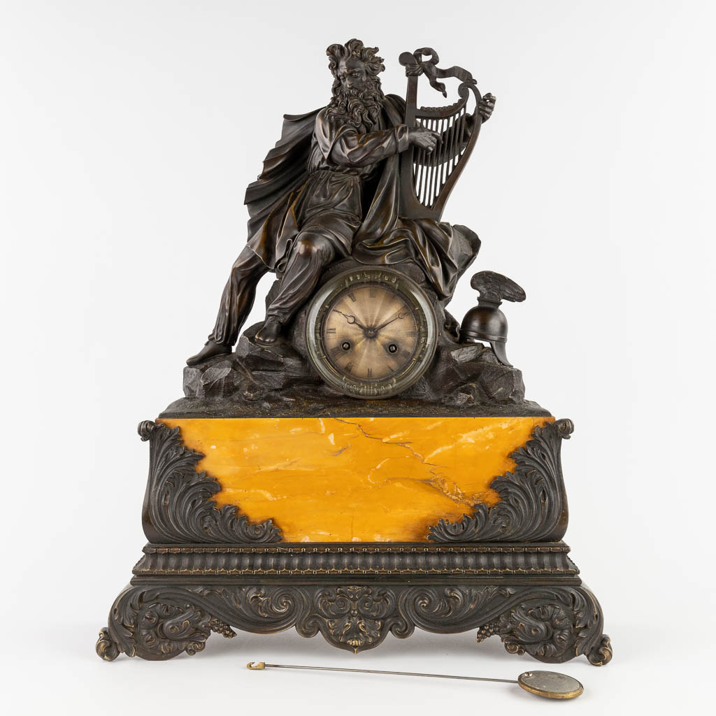 An antique mantle clock 'Bragi with a harp' patinated bronze on marble. 19th C. (D:14 x W:44 x H:54 cm)